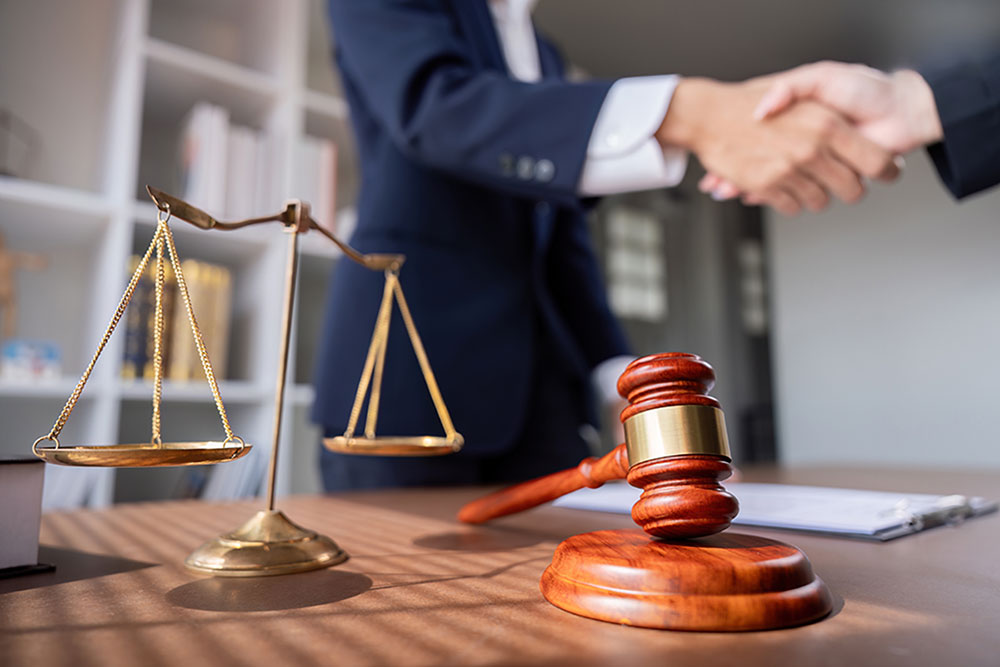 two sexual assault and harassment lawyers shake hands